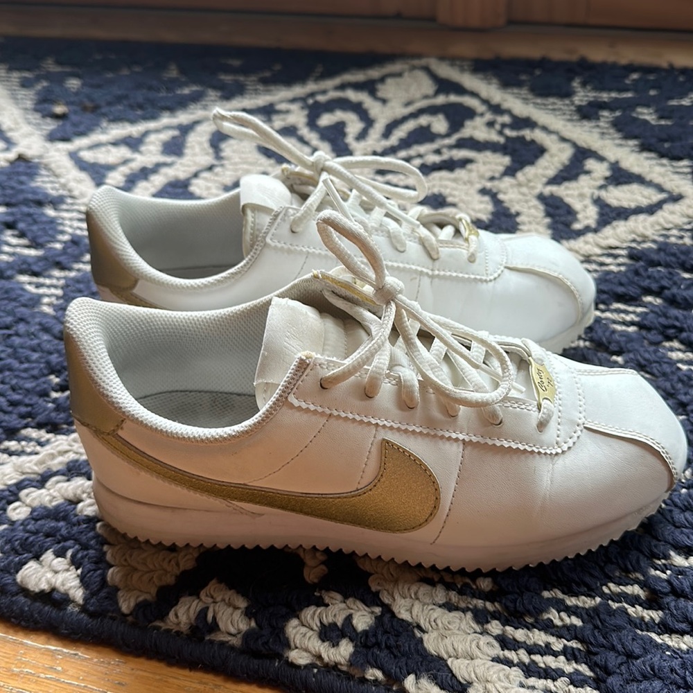 White and gold Nike Cortez